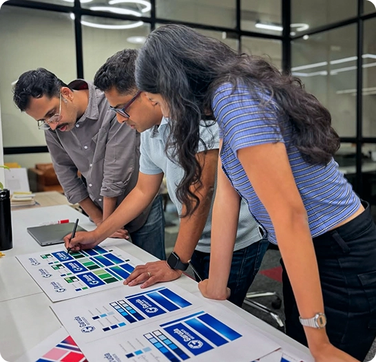 The team reviewing work on the wall